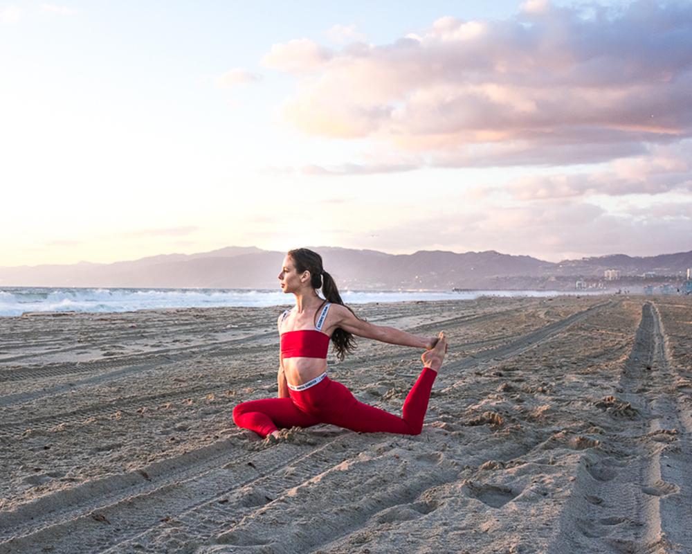 Premium Photo | Unknown latin woman stretching or doing yoga on the beach  at sunset